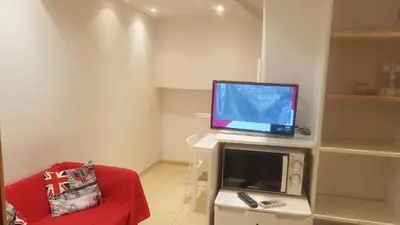 a living room with a tv and a computer on a table at 016 DUPLEX centric in Barcelona