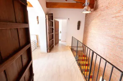a hallway with a brick wall and a staircase at Sun & Sand Sanctuary - 2km to beach and 20km BCN! in Castelldefels