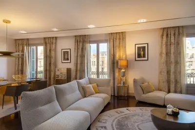 a living room with a couch and a table at Paseo de Gracia Icon Apartment in Barcelona