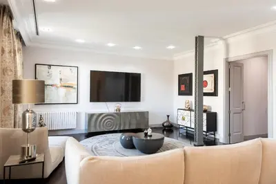 a living room with a couch and a table at Paseo de Gracia Icon Apartment in Barcelona