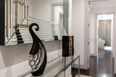 a glass case with a black swan on a shelf at Paseo de Gracia Icon Apartment in Barcelona