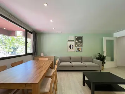 a living room with a table and a couch at Stay U-nique Apartment Roma in Barcelona