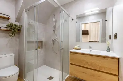 a bathroom with a shower and a toilet and a sink at Lodging Apartments Almirall Beach B1 in Barcelona