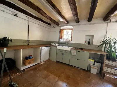 a kitchen with a counter and a sink and a window at Maset del Garraf in Olesa de Bonesvalls