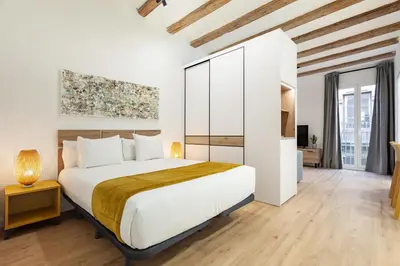 a bedroom with a large bed with a wooden floor at Art House Travessera de Gràcia-2 in Barcelona