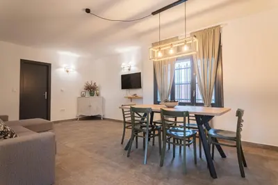 a living room with a dining room table and chairs at Can Davilas Rustic Mountain House in Monistrol de Calders