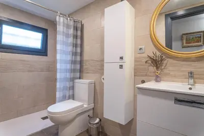 a bathroom with a toilet and a sink and a mirror at Can Davilas Rustic Mountain House in Monistrol de Calders