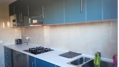 a kitchen with blue cabinets and a sink at La Casa de Vacaciones in Terrassa