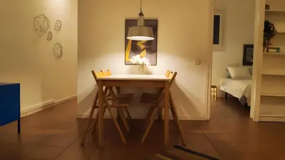a table and chairs in a room with a bed at Rambla-Plça Catalunya 2BR monthly stays -R.H in Barcelona