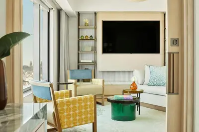 a living room with a couch and a tv at Hotel Arts Barcelona in Barcelona