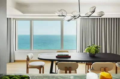 a dining room with a table and a view of the ocean at Hotel Arts Barcelona in Barcelona