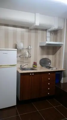a kitchen with a sink and a white refrigerator at Coliving 87 estudio numero 10 in Barcelona