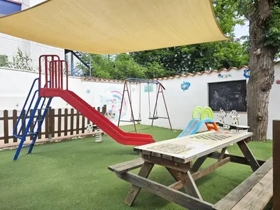a playground with a slide and a table at Costa Dorada Tiny Amaia in Canet de Mar