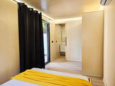 a bedroom with a bed with a yellow blanket at Costa Dorada Tiny Amaia in Canet de Mar
