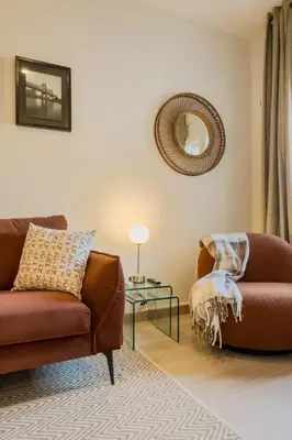 a living room with a couch and a table at Apartamento cerca de Camp Nou in Hospitalet de Llobregat