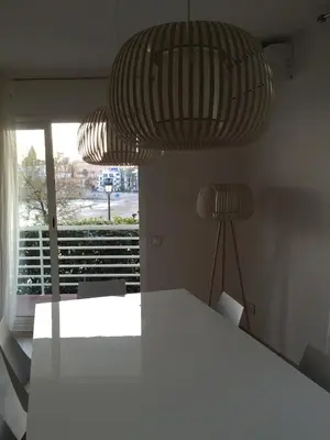 a dining room with a white table and a lamp at Rustic good in Sitges