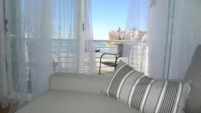 a couch in front of a window with a view of the ocean at Rustic good in Sitges