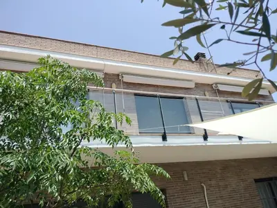 a building with windows on the side of it at Large house surrounded by nature in Vilanova de la Roca