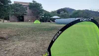 a green tent in a field next to a building at Large house surrounded by nature in Vilanova de la Roca