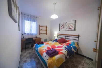 a bedroom with a bed with a cat pillow on it at Comodo y luminoso en Cornella -Barcelona- in Cornellà de Llobregat
