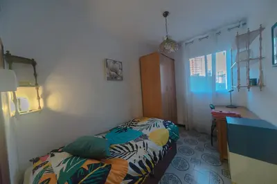 a small bedroom with a bed and a window at Comodo y luminoso en Cornella -Barcelona- in Cornellà de Llobregat