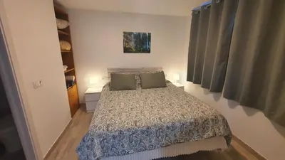 a bedroom with a bed with two green pillows at Vallgorguina Uno in Vallgorguina
