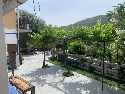 a garden with trees and plants on a balcony at El Portal, 12 mins from Sitges in Olivella