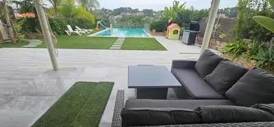 a living room with a couch and a swimming pool at The Family Palace in Piera