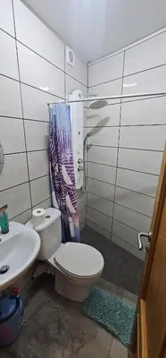 a bathroom with a toilet and a sink at The Family Palace in Piera