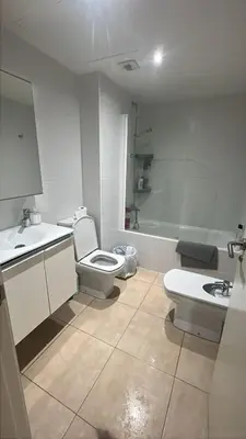 a bathroom with a toilet and a sink and a tub at Habitación mediana in Santa Coloma