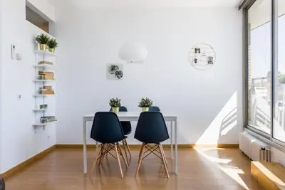 a dining room with two chairs and a table at Lodging Apartments Beach Apartment Villa Olimpica in Barcelona