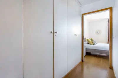 a bedroom with a bed and a large mirror at Lodging Apartments Beach Apartment Villa Olimpica in Barcelona