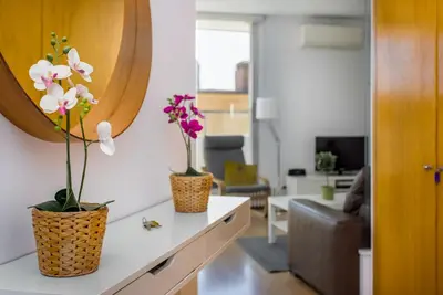 two vases with flowers on a counter in a living room at Lodging Apartments Beach Apartment Villa Olimpica in Barcelona