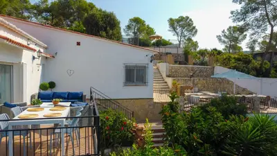 a balcony of a house with a table and chairs at Mikasi Hills by Hello Homes Sitges in Sant Pere de Ribes