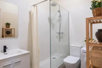a bathroom with a shower and a toilet and a sink at Charm and Comfort in the Heart of Sant Antoni, Barcelona in Barcelona
