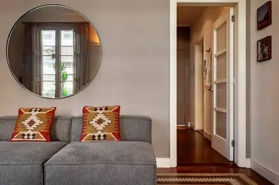 a bedroom with a bed and a mirror at Zagora - 2 bedrooms in Eixample Dreta in Barcelona