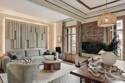 a living room with a couch and a table at Lura - 2 bedrooms and terrace in Eixample Esquerra in Barcelona