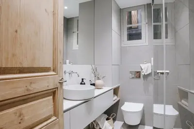 two chairs and a table in a room with a kitchen at Alajar - 3 bedrooms in St Pere Sta Caterina in Barcelona