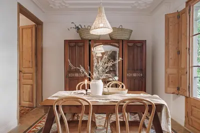 a bedroom with a fireplace and a chair and a mirror at Alajar - 3 bedrooms in St Pere Sta Caterina in Barcelona