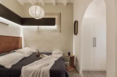a bedroom with a bed and a chair and a chair at Tiqui - 1 bedroom and balcony in Vila de Gràcia in Barcelona