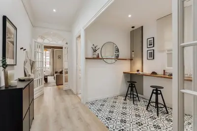 a living room with a bed and a couch and a mirror at Quira - 4 bedrooms and balcony in Eixample Dreta in Barcelona