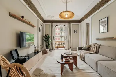 a living room with a couch and a table at Quira - 4 bedrooms and balcony in Eixample Dreta in Barcelona