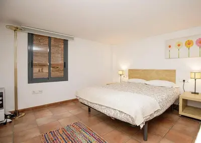 a bedroom with a bed and a window at Urban Gracia in Barcelona