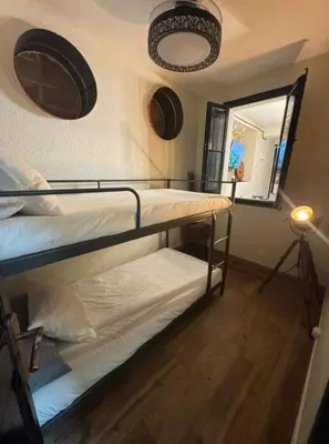 two bunk beds in a room with a mirror at Hermoso Apartamento cerca a Barcelona in Sant Adria de Besos