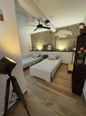 a bedroom with two beds and a ceiling fan at Hermoso Apartamento cerca a Barcelona in Sant Adria de Besos