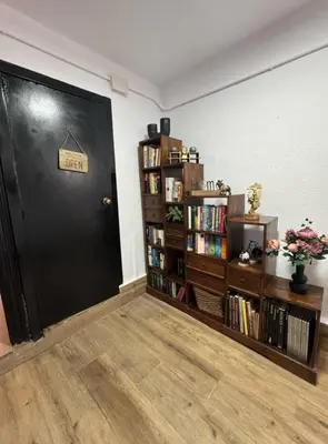 a black door in a room with a book shelf at Hermoso Apartamento cerca a Barcelona in Sant Adria de Besos