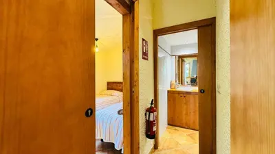 a room with a bedroom with a bed and a fire hydrant at Apartament rural in San Martín Sarroca