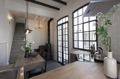 a kitchen with a table and some windows at Traumhäuschen am Meer für 2, Barcelona in Vilassar de Mar