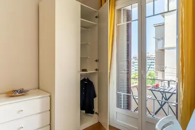 a walk in closet with a glass door and a window at Canela Homes BARCELONA GLÒRIES in Barcelona