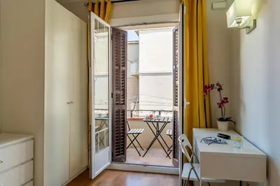 a room with a door to a balcony with a table at Canela Homes BARCELONA GLÒRIES in Barcelona